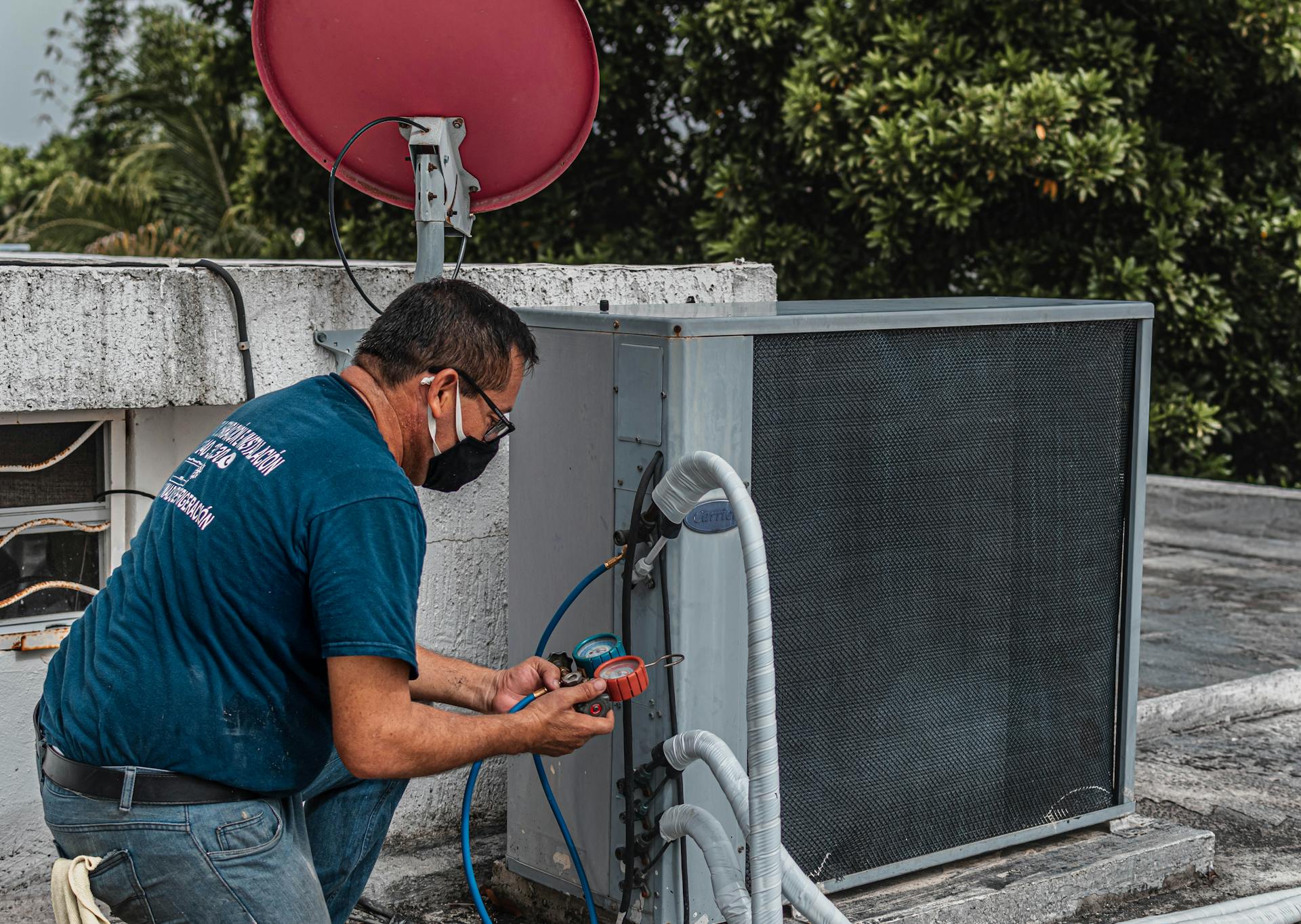 HVAC technician servicing an air conditioning unit